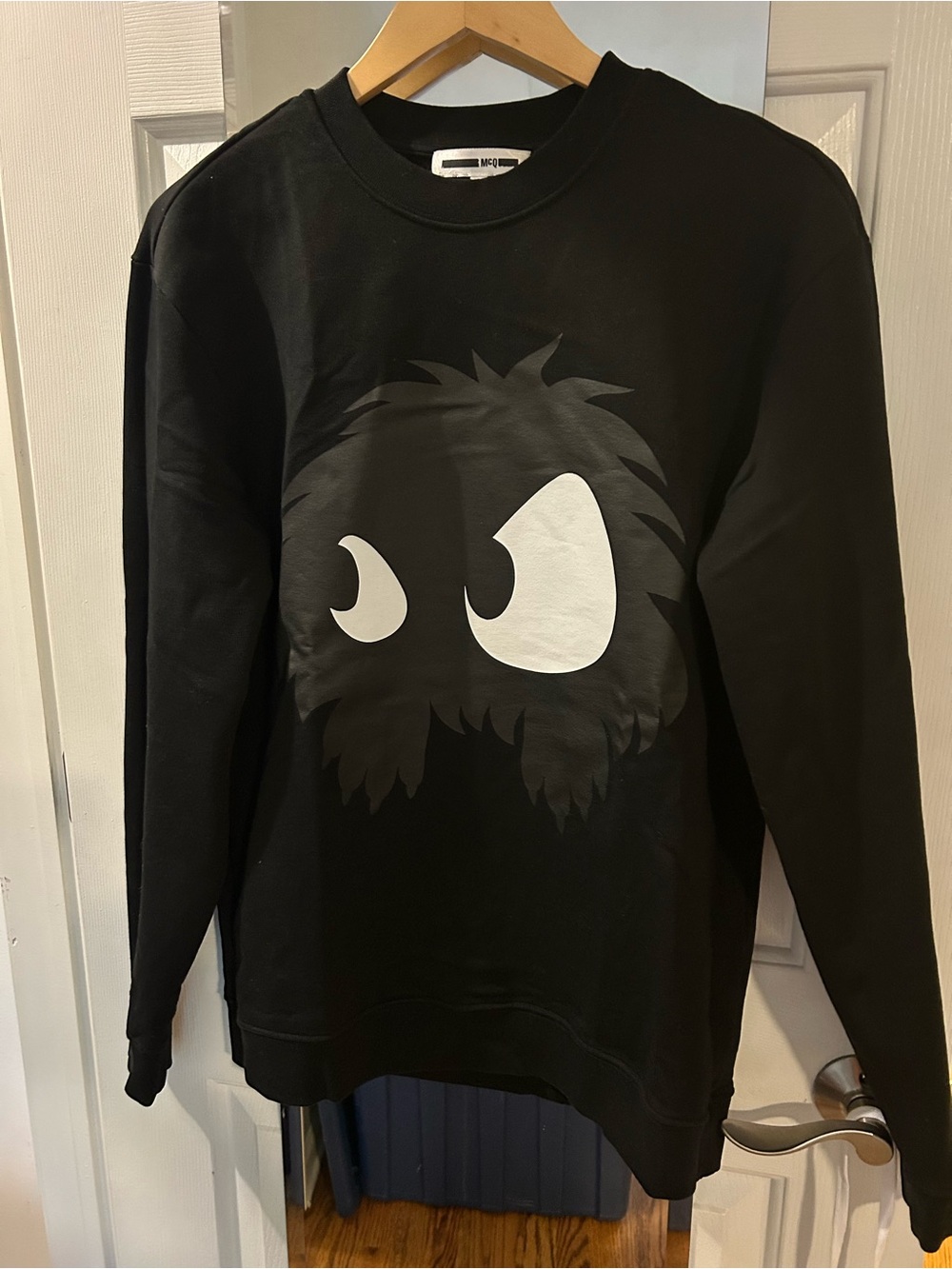 McQ by Alexander McQueen Black Crewneck with White Eye Graphic